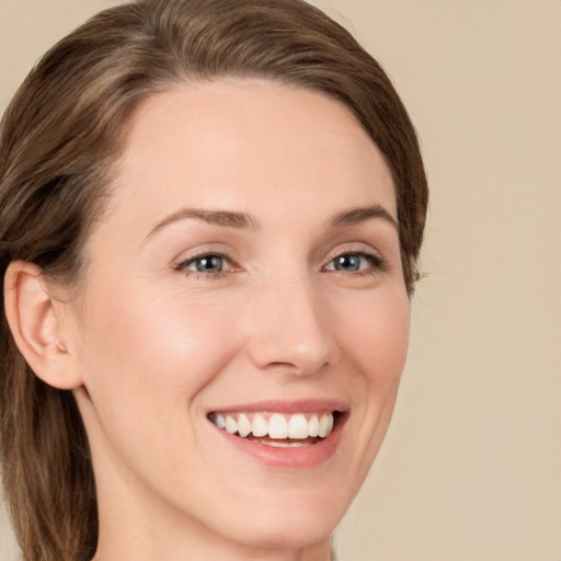 Joyful white young-adult female with medium  brown hair and grey eyes