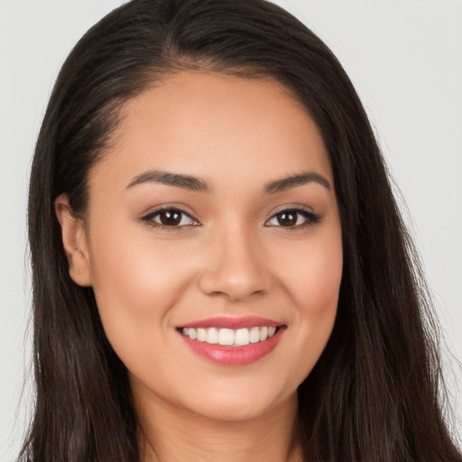 Joyful white young-adult female with long  brown hair and brown eyes