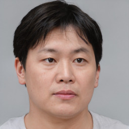 Neutral asian young-adult male with short  brown hair and brown eyes