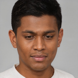 Joyful latino young-adult male with short  brown hair and brown eyes