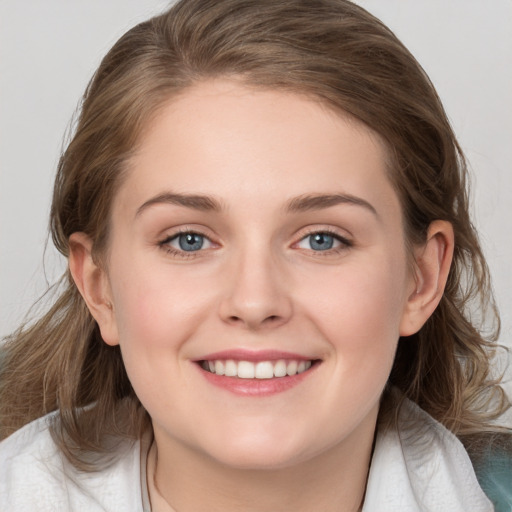 Joyful white young-adult female with medium  brown hair and blue eyes