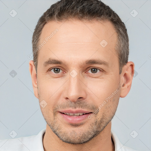 Joyful white adult male with short  brown hair and brown eyes