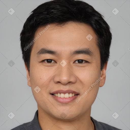 Joyful asian young-adult male with short  black hair and brown eyes