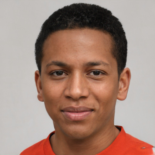 Joyful black young-adult male with short  black hair and brown eyes