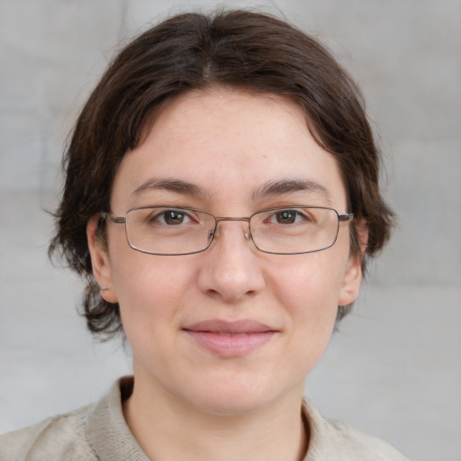 Joyful white adult female with medium  brown hair and grey eyes