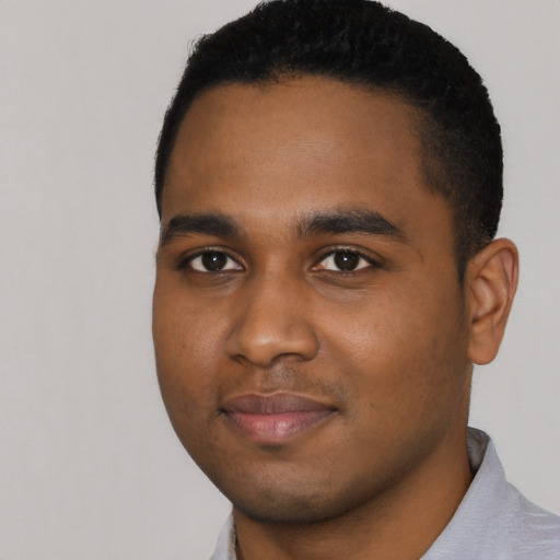 Joyful black young-adult male with short  black hair and brown eyes