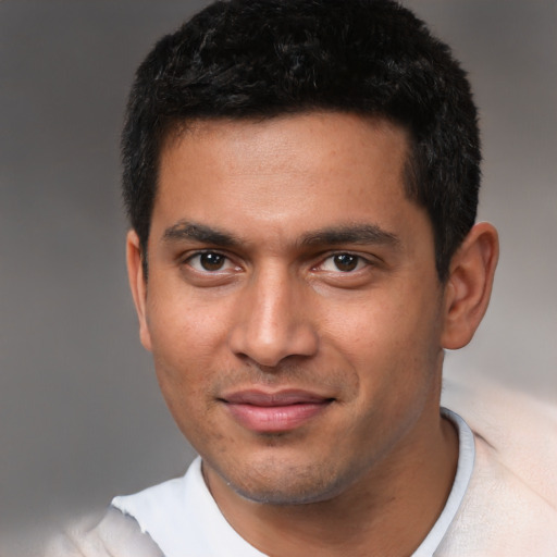 Joyful latino young-adult male with short  black hair and brown eyes