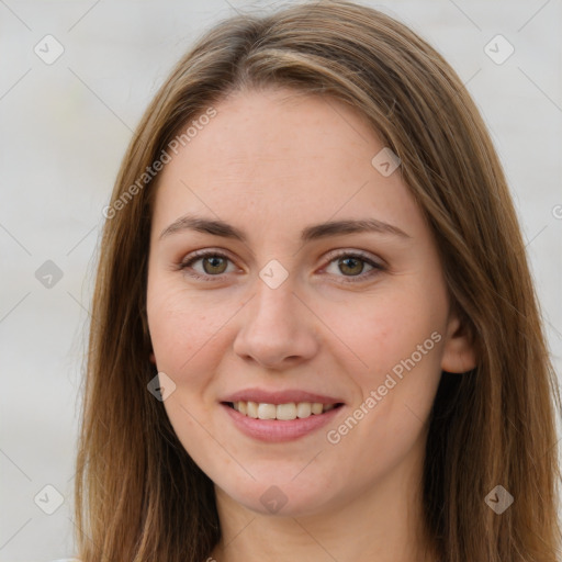 Joyful white young-adult female with long  brown hair and green eyes