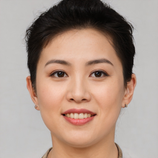 Joyful asian young-adult female with short  brown hair and brown eyes