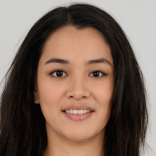 Joyful asian young-adult female with long  brown hair and brown eyes