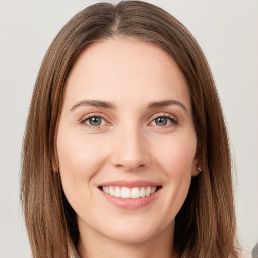 Joyful white young-adult female with long  brown hair and green eyes