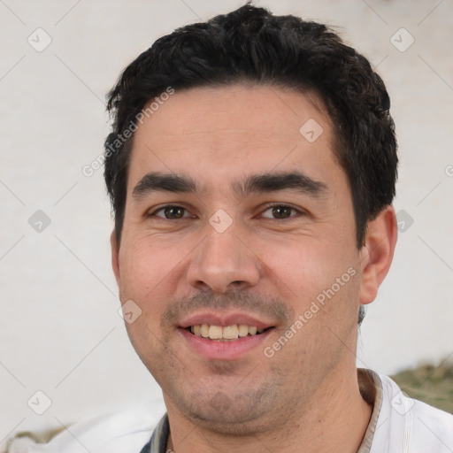 Joyful white young-adult male with short  black hair and brown eyes