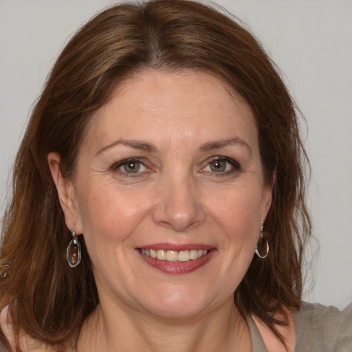 Joyful white adult female with medium  brown hair and brown eyes