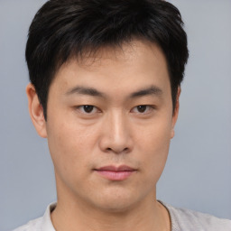 Neutral asian young-adult male with short  brown hair and brown eyes