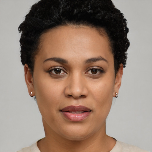 Joyful black young-adult female with short  brown hair and brown eyes