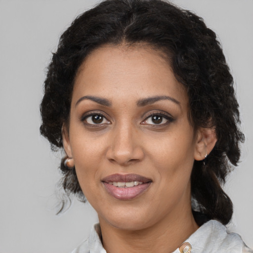 Joyful black young-adult female with medium  brown hair and brown eyes