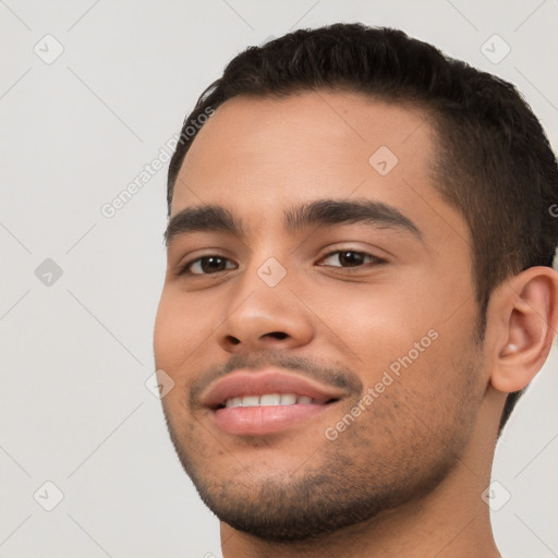 Joyful white young-adult male with short  black hair and brown eyes