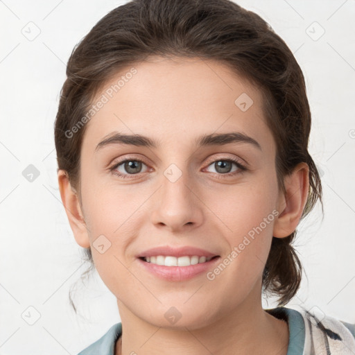 Joyful white young-adult female with medium  brown hair and grey eyes