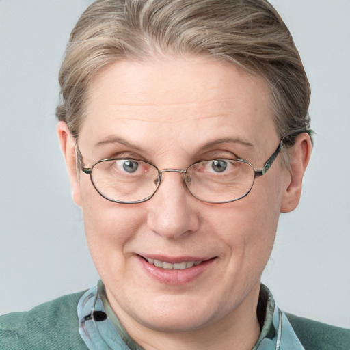 Joyful white adult female with short  brown hair and blue eyes