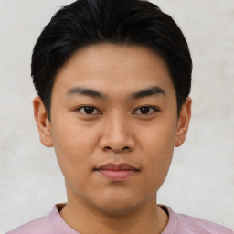 Joyful asian young-adult male with short  black hair and brown eyes