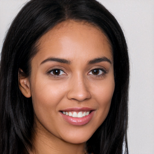 Joyful latino young-adult female with long  brown hair and brown eyes