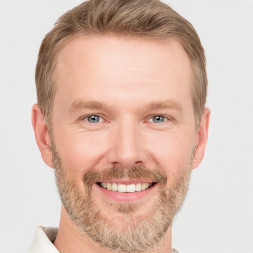 Joyful white adult male with short  brown hair and grey eyes