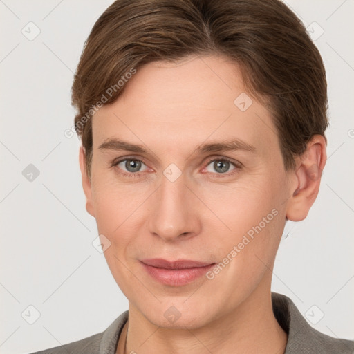 Joyful white young-adult female with short  brown hair and grey eyes