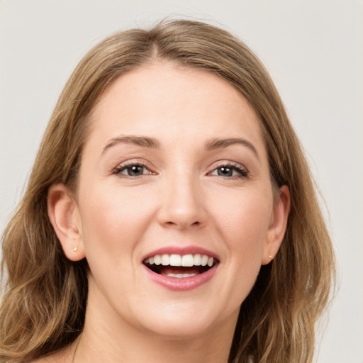 Joyful white young-adult female with long  brown hair and grey eyes