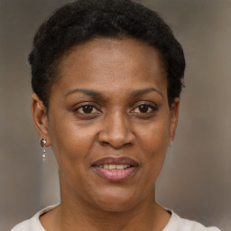 Joyful black adult female with short  brown hair and brown eyes