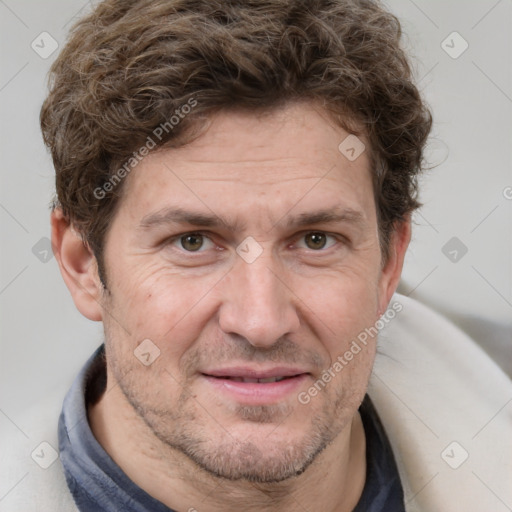 Joyful white adult male with short  brown hair and grey eyes