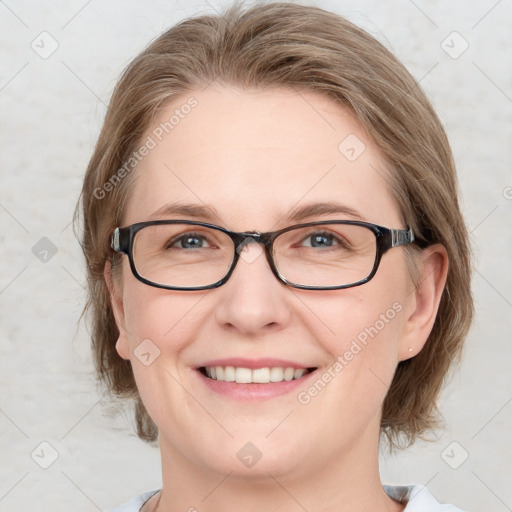 Joyful white adult female with medium  brown hair and blue eyes