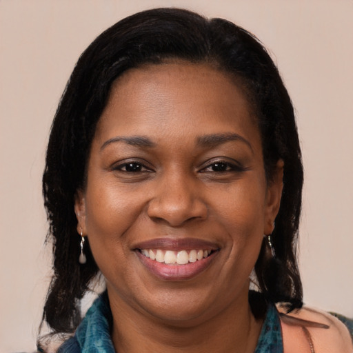 Joyful black young-adult female with medium  brown hair and brown eyes