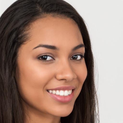 Joyful latino young-adult female with long  brown hair and brown eyes