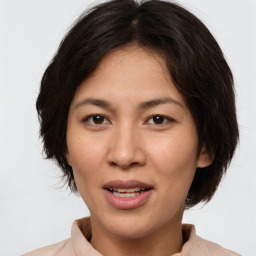 Joyful white adult female with medium  brown hair and brown eyes