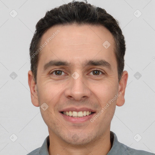 Joyful white adult male with short  brown hair and brown eyes