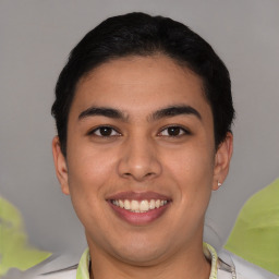 Joyful latino young-adult male with short  brown hair and brown eyes