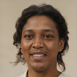 Joyful latino adult female with medium  brown hair and brown eyes