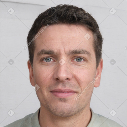 Joyful white adult male with short  brown hair and brown eyes