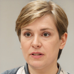 Joyful white adult female with medium  brown hair and grey eyes