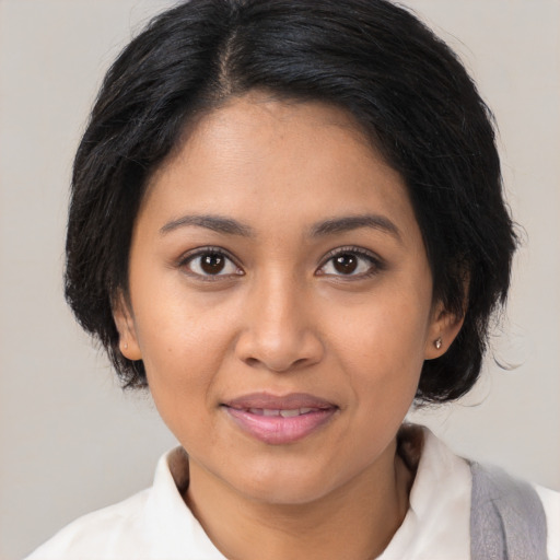 Joyful latino young-adult female with medium  black hair and brown eyes