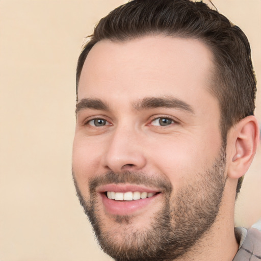 Joyful white young-adult male with short  brown hair and brown eyes