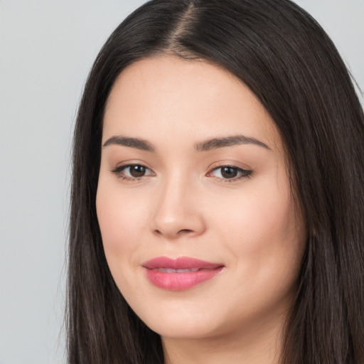 Joyful white young-adult female with long  black hair and brown eyes