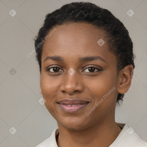 Joyful black young-adult female with short  brown hair and brown eyes