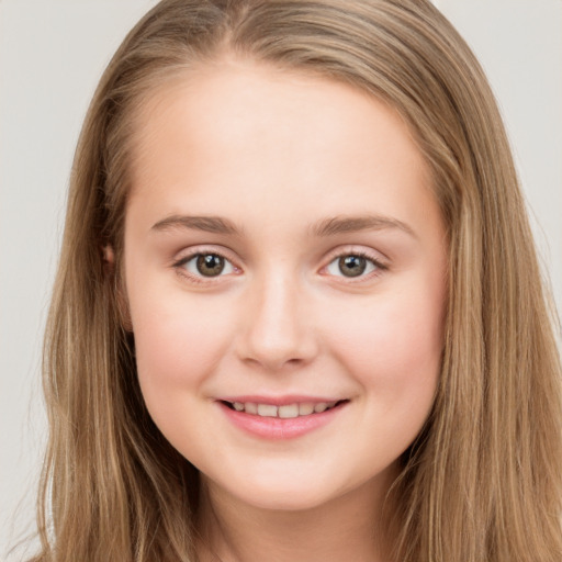 Joyful white child female with long  brown hair and brown eyes