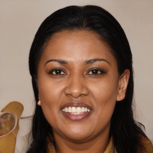 Joyful black adult female with long  black hair and brown eyes