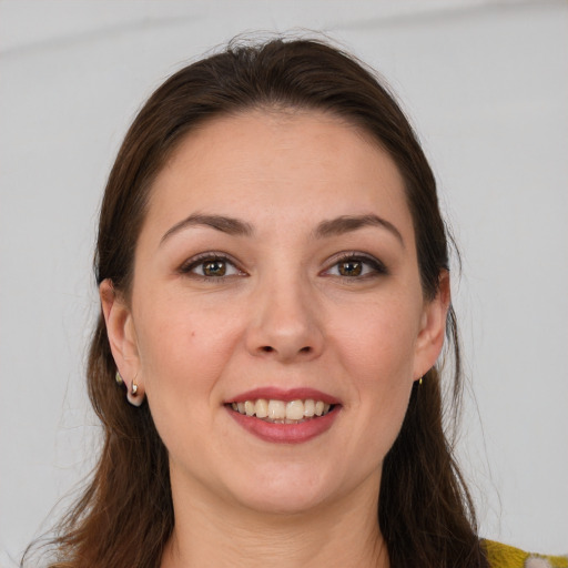 Joyful white young-adult female with long  brown hair and grey eyes