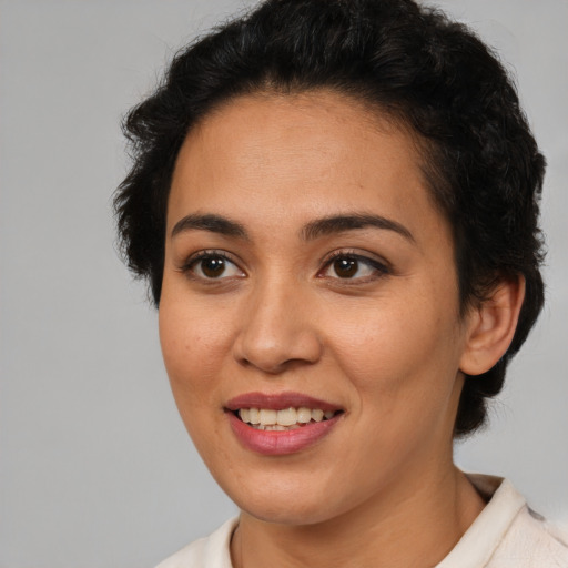 Joyful latino young-adult female with short  brown hair and brown eyes