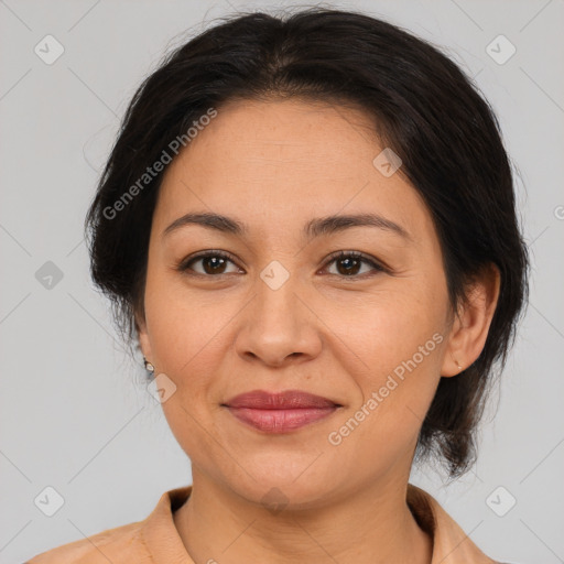 Joyful asian adult female with medium  brown hair and brown eyes