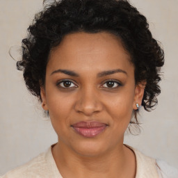 Joyful black young-adult female with medium  brown hair and brown eyes