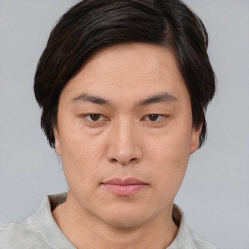 Neutral asian young-adult male with short  brown hair and brown eyes